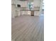 Modern kitchen with white cabinetry, stainless steel appliances, granite countertops, and hardwood floors at 812 Kenmore Ave, Louisburg, NC 27549