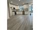 Open kitchen with white cabinets, stainless steel appliances, and light gray flooring at 812 Kenmore Ave, Louisburg, NC 27549