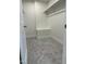 This walk-in closet has a carpeted floor, white walls, and a built-in shelf at 812 Kenmore Ave, Louisburg, NC 27549