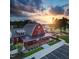 Stunning aerial view of community clubhouse and park amenities at sunset at 88 Windchime Ct, Fuquay Varina, NC 27526