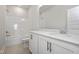 Bright bathroom with white cabinets, quartz countertops, and tub with shower at 88 Windchime Ct, Fuquay Varina, NC 27526