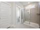 Bathroom featuring glass enclosed shower, neutral tile and bright natural light at 88 Windchime Ct, Fuquay Varina, NC 27526