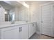 Bathroom with double vanity, quartz countertops, and large mirror at 88 Windchime Ct, Fuquay Varina, NC 27526