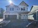 New construction home featuring an attached two-car garage and covered entry, with a bright sunlit view at 88 Windchime Ct, Fuquay Varina, NC 27526
