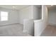 Upstairs hallway with neutral carpet and crisp white trim and walls at 88 Windchime Ct, Fuquay Varina, NC 27526