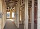 Interior framing featuring the raw construction and exposed wood, showcasing the layout of the future rooms at 88 Windchime Ct, Fuquay Varina, NC 27526