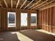 Wood-framed interior with natural light streaming through window openings showcasing the house under construction at 88 Windchime Ct, Fuquay Varina, NC 27526