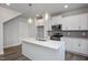 Bright, all-white kitchen features quartz counters, pendant lighting, and stainless appliances at 88 Windchime Ct, Fuquay Varina, NC 27526