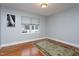 Simple bedroom features hardwood floors, a neutral wall, and a carpet at 1005 W Club Blvd, Durham, NC 27701