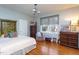 Spacious bedroom with hardwood floors, neutral walls, large window, and vintage furniture at 1005 W Club Blvd, Durham, NC 27701