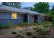 Charming home featuring a stone walkway, updated exterior, lush landscaping, and inviting curb appeal at 1005 W Club Blvd, Durham, NC 27701