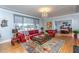 Cozy living room featuring hardwood floors, a chandelier, and access to the dining room at 1005 W Club Blvd, Durham, NC 27701