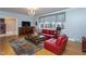 Inviting living room with large windows, hardwood floors, and comfortable red seating at 1005 W Club Blvd, Durham, NC 27701