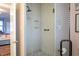 Bright shower room with tiled walls and floor, glass door, and built-in shelves at 1005 W Club Blvd, Durham, NC 27701