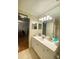 Well-lit bathroom with a sink, a large mirror, and ample storage at 1513 E Franklin St # C129, Chapel Hill, NC 27514
