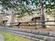 Townhome featuring wood stairs, neutral siding, and a stone retaining wall at 1513 E Franklin St # C129, Chapel Hill, NC 27514