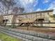 Charming two-story apartments with wooden stairs, decks, and retaining wall in a community setting at 1513 E Franklin St # C129, Chapel Hill, NC 27514