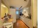 Kitchen with white cabinetry, stainless steel appliances and wooden floors at 1513 E Franklin St # C129, Chapel Hill, NC 27514