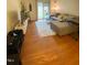 Cozy living room with plush gray couch, hardwood floors, and sliding glass doors to the patio at 1513 E Franklin St # C129, Chapel Hill, NC 27514