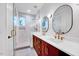 Modern bathroom featuring double sinks, stylish mirrors, and a glass-enclosed shower at 1604 Malta Ave, Raleigh, NC 27610