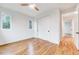 Bright bedroom featuring hardwood floors, a closet, and multiple windows at 1604 Malta Ave, Raleigh, NC 27610