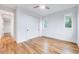 Light-filled bedroom featuring hardwood floors and a closet with sliding doors at 1604 Malta Ave, Raleigh, NC 27610