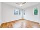 Sunlit bedroom boasting hardwood floors and multiple windows at 1604 Malta Ave, Raleigh, NC 27610