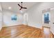 Bright bedroom with hardwood floors, ceiling fan, and a door leading to a balcony at 1604 Malta Ave, Raleigh, NC 27610