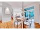 Bright dining room with a modern light fixture, hardwood floors, and view to the outdoor patio at 1604 Malta Ave, Raleigh, NC 27610
