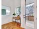 Inviting entryway featuring herringbone hardwood floors, a modern table, and a view to the outside at 1604 Malta Ave, Raleigh, NC 27610