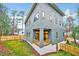 Modern home with an open patio, large windows, a fenced yard, and lush greenery at 1604 Malta Ave, Raleigh, NC 27610