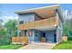 Modern home featuring blue siding, sleek lines, a second-story deck, and inviting curb appeal at 1604 Malta Ave, Raleigh, NC 27610