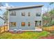 Contemporary home featuring a sleek exterior, large windows, and a well-maintained lawn at 1604 Malta Ave, Raleigh, NC 27610