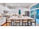Bright kitchen with white cabinets, a large central island, and stainless steel appliances at 1604 Malta Ave, Raleigh, NC 27610