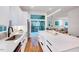 Modern kitchen featuring white cabinets, stainless steel appliances, a large island, and hardwood floors at 1604 Malta Ave, Raleigh, NC 27610
