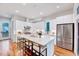Spacious kitchen featuring white cabinets, a large island with seating, and modern lighting at 1604 Malta Ave, Raleigh, NC 27610