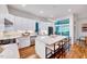 Modern kitchen features white cabinetry, stainless steel appliances, and a large center island at 1604 Malta Ave, Raleigh, NC 27610