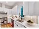 Close up of the kitchen with white cabinets, stainless steel appliances, and a sleek design at 1604 Malta Ave, Raleigh, NC 27610