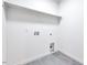 Practical laundry room with tile flooring and shelving for storage at 1604 Malta Ave, Raleigh, NC 27610