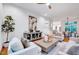 Spacious living room featuring a modern entertainment center and neutral colored furniture at 1604 Malta Ave, Raleigh, NC 27610