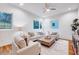 Bright living room with a ceiling fan, neutral decor, and hardwood floors at 1604 Malta Ave, Raleigh, NC 27610