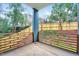 Modern patio featuring custom wood railing and serene wooded views at 1604 Malta Ave, Raleigh, NC 27610