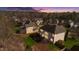 Aerial view of a house in a wooded suburban setting. The backyard has a deck at 1610 Creighton Hall Way, Durham, NC 27703