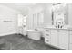 A luxurious bathroom with a freestanding tub, dual vanities, stylish fixtures, and elegant tile flooring at 1804 Clifton Pines Dr, Cary, NC 27519