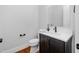 Elegant powder room features dark vanity with gold hardware, and a modern sink at 1804 Clifton Pines Dr, Cary, NC 27519