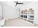 Comfortable bedroom featuring built-in shelving, plush carpet, and a ceiling fan at 1804 Clifton Pines Dr, Cary, NC 27519