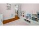 Cozy bedroom view showcasing a white shelving unit and access to an open doorway at 1804 Clifton Pines Dr, Cary, NC 27519