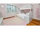 Charming bedroom with a white bunk bed and a decorative pink rug at 1804 Clifton Pines Dr, Cary, NC 27519