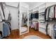 Spacious walk-in closet with ample shelving and hanging space, enhanced by hardwood floors at 1804 Clifton Pines Dr, Cary, NC 27519