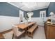 Bright dining room with elegant lighting, bench seating and views to the kitchen at 1804 Clifton Pines Dr, Cary, NC 27519